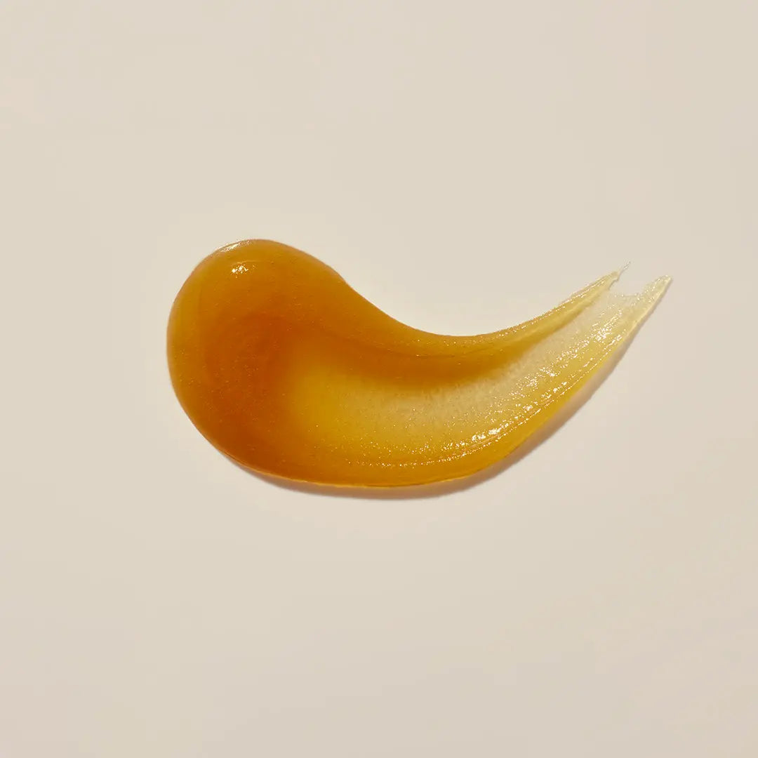Amber-colored gel or cream on a beige background