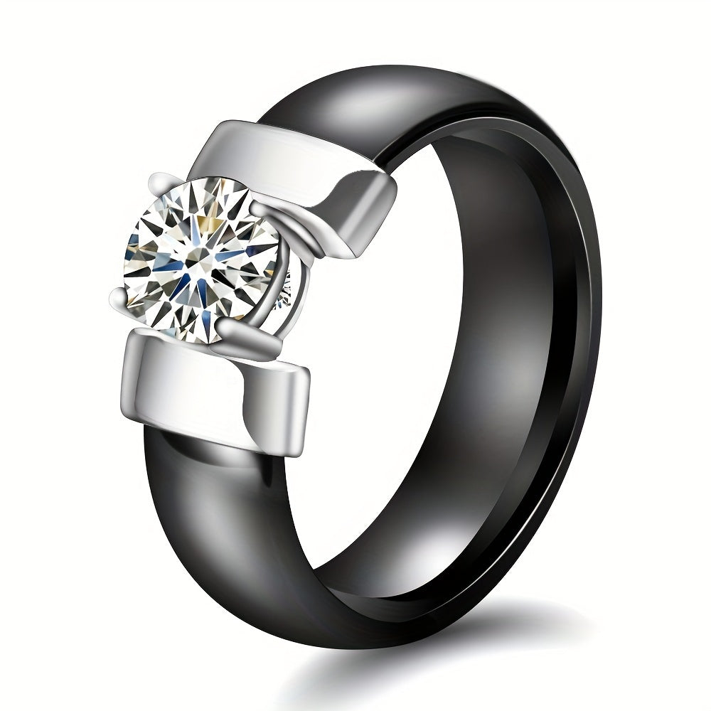 Black and silver ring with a diamond on a white background