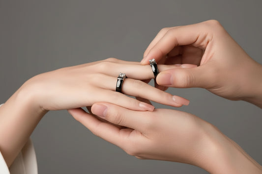 Close-up of a hand wearing a ring with a gray background