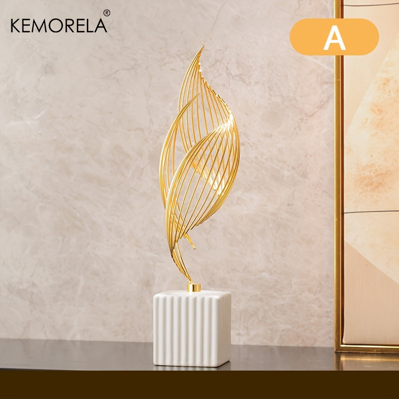 Decorative gold leaf sculpture on a white base against a beige wall with KEMORELA branding.