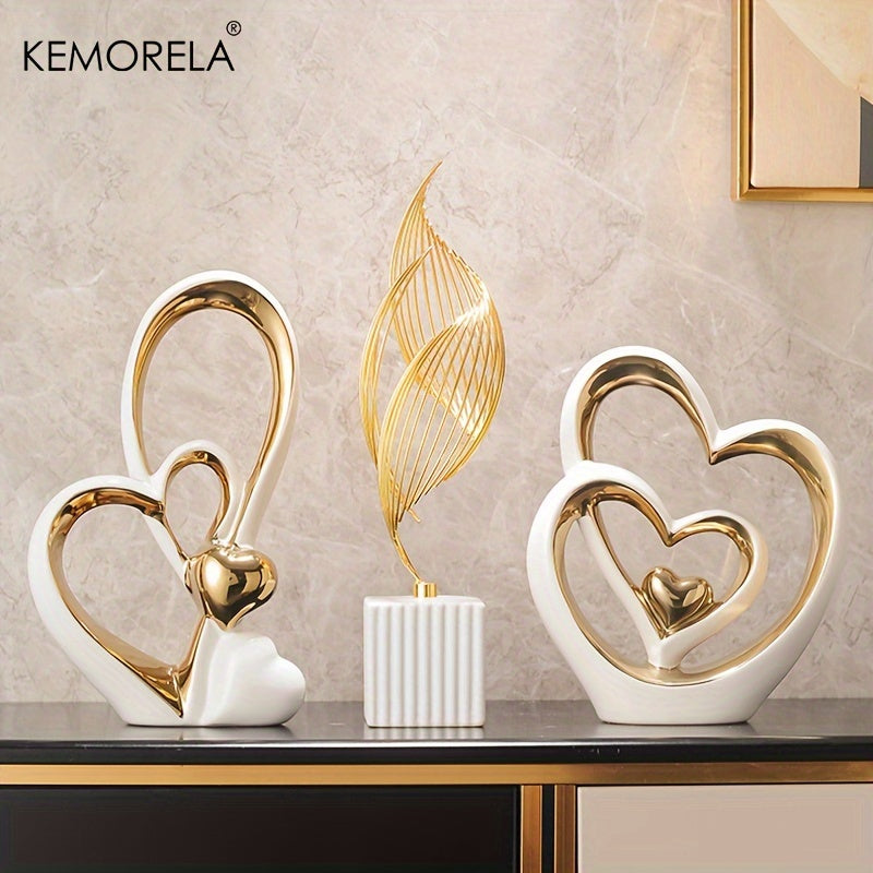 Decorative items with heart designs on a table against a marble wall, featuring the brand 'KEMORELA'.