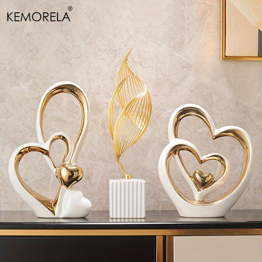 Decorative items with heart designs on a table against a marble wall, featuring the brand 'KEMORELA'.