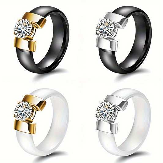 Four rings with gold, silver, and white bands featuring diamond-like centers on a white background.