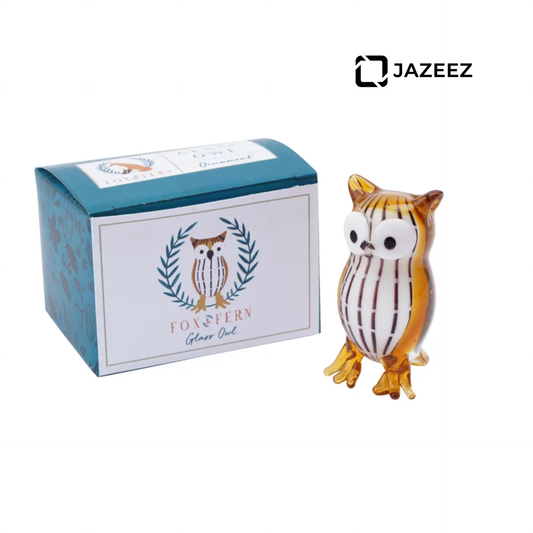 Glass owl figurine with a branded box on a white background