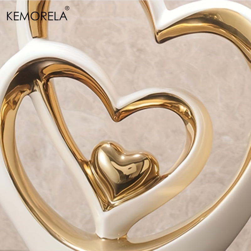 Gold heart-shaped object with white background, featuring KEMORELA brand.