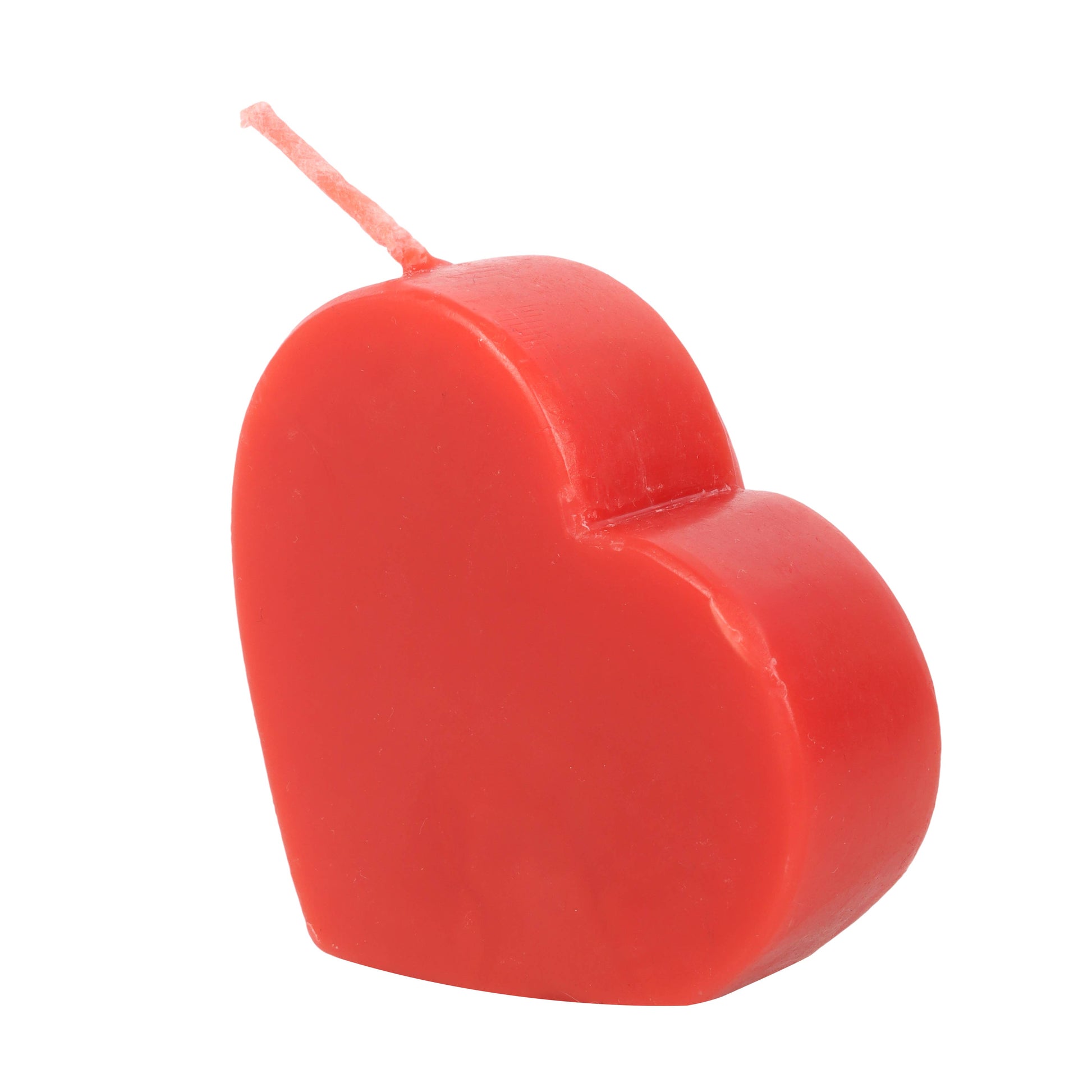 Red heart-shaped candle on a white background